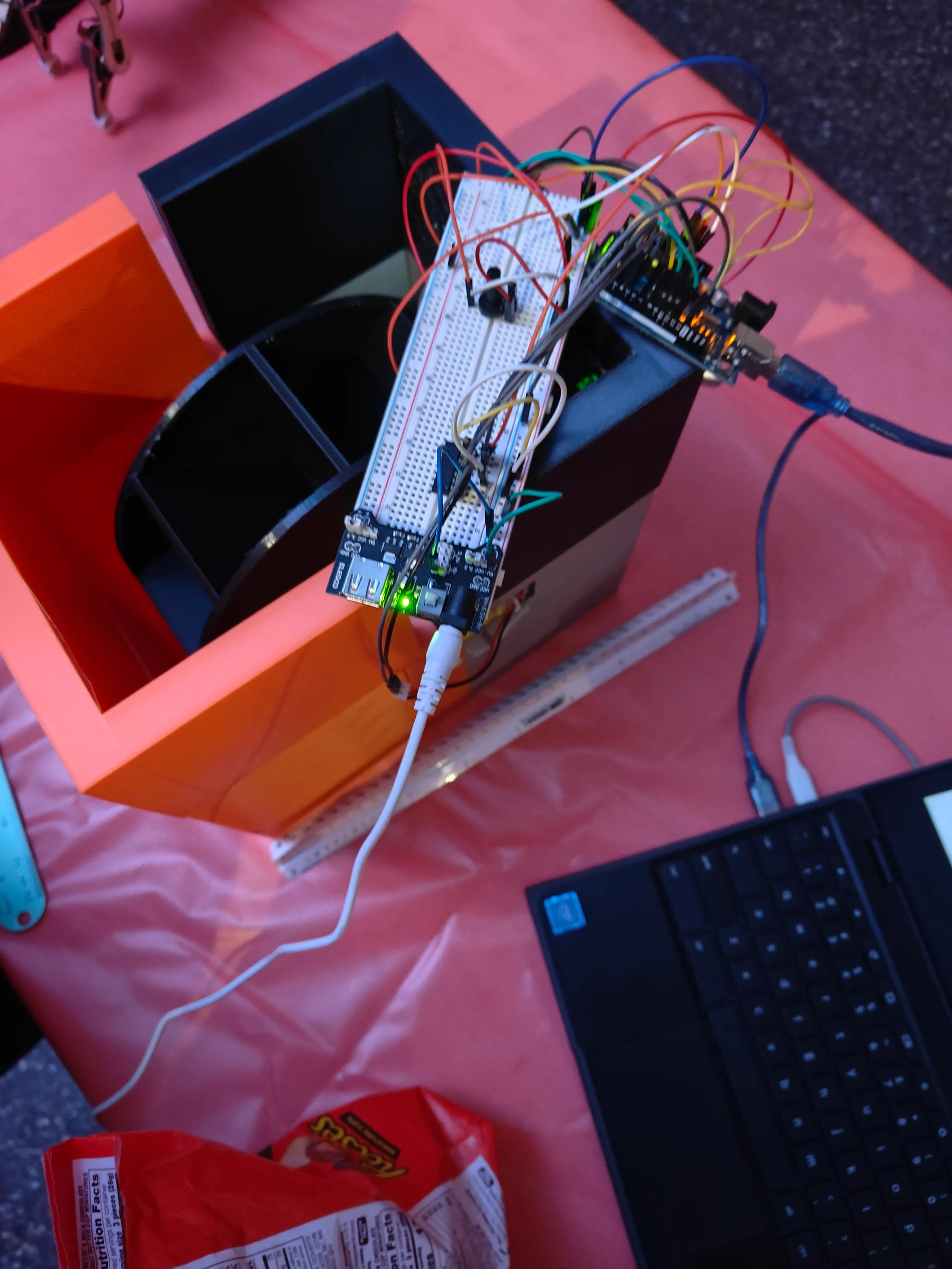 CandyBot with its electronics unmounted, showing the breadboard motor driver and Ferris-wheel dispensing mechanism
